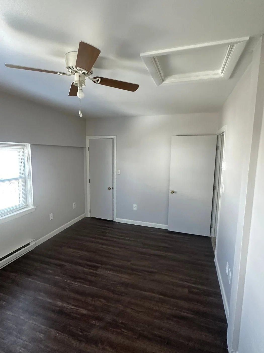 Second room showing completed LVP floors and freshly painted interior